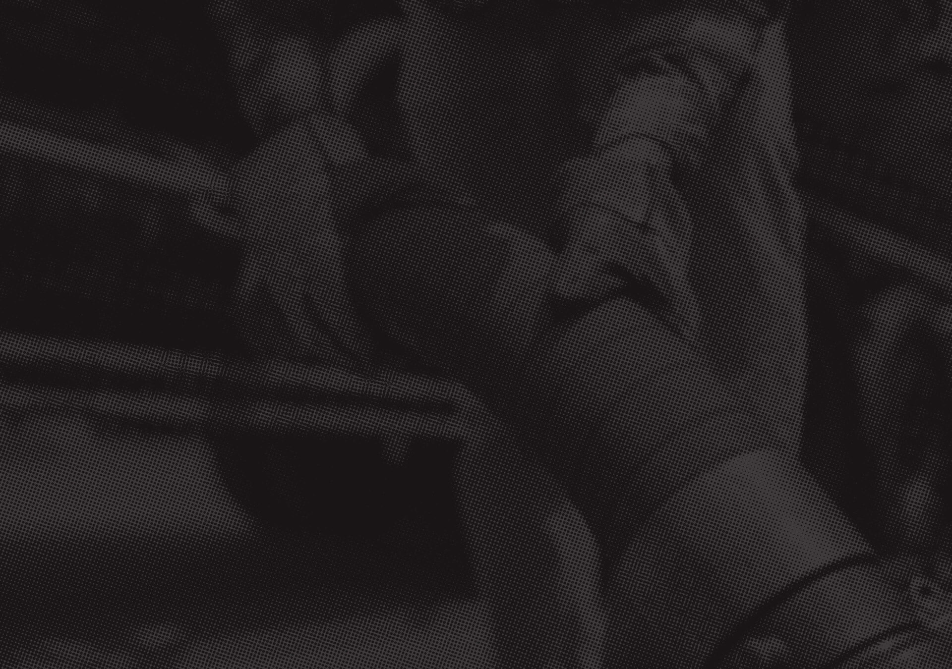 Image of employee handling hose with black overlay and halftone treatment