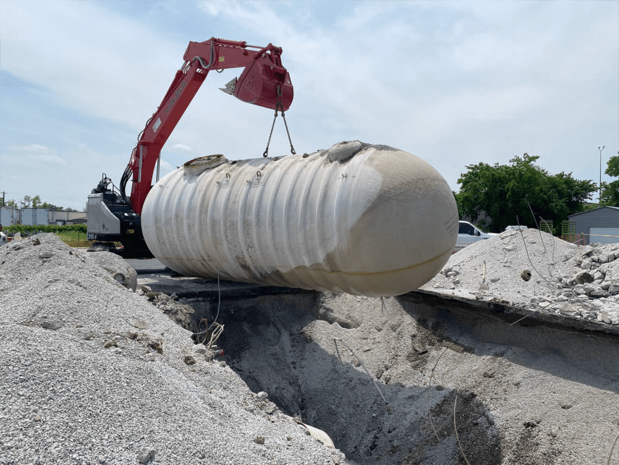 Photo of tank being lowered into ground